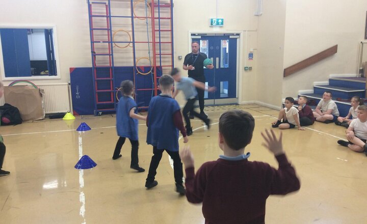 Image of This afternoon in PE with Sam, the children focused on practising forward throws, bounce throws, and dribbling skills. They all worked incredibly hard!